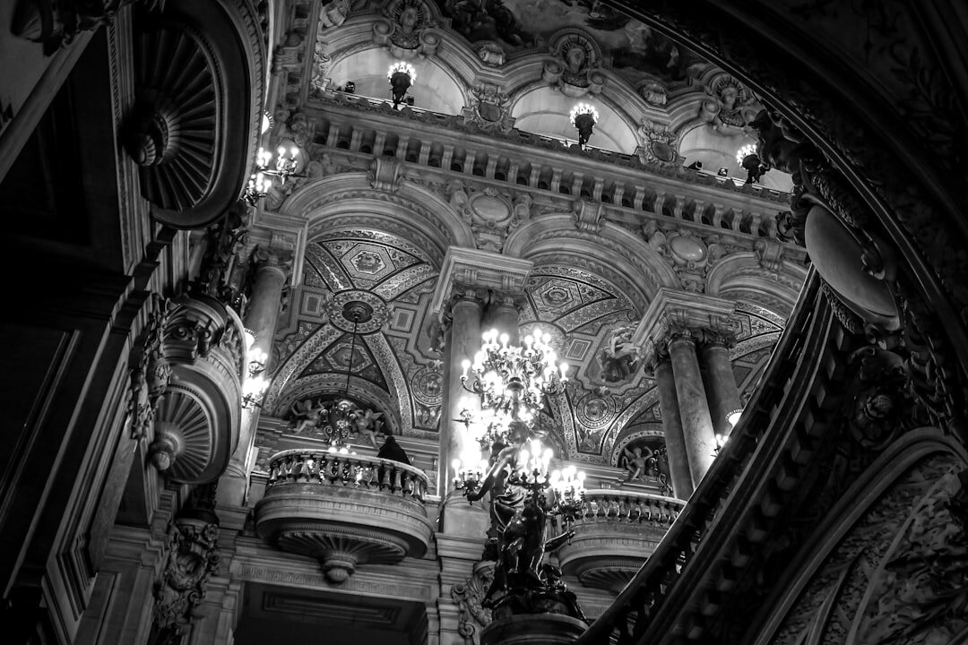 Grand opera house interior with ornate balconies and warm gilded lighting