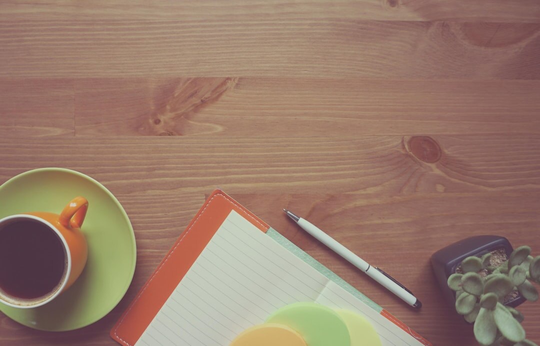 Elegant desk with an open agenda, pen and coffee cup